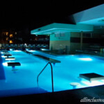 Swim-up bar pool at night