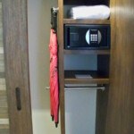 Umbrellas, digital safe, and shelf space in the closet Hotel Xcaret Mexico Closet