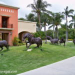 Sculptures outside the Colonial Barcelo Maya Colonial sculptures