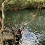 You have a choice of how to enter--there are two sets of stairs, two jumping platforms, and a zipline where you let go of the line and drop into the water