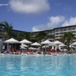 Lots of pool loungers and shade umbrellas